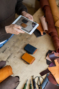 High angle view of man using smart phone on table