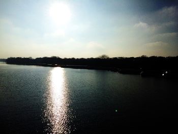 Scenic view of river against sky during sunset
