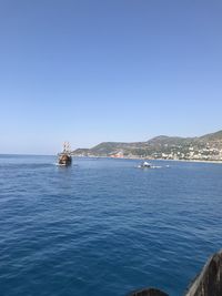 Scenic view of sea against clear blue sky