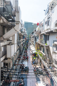 High angle view of buildings by canal against sky