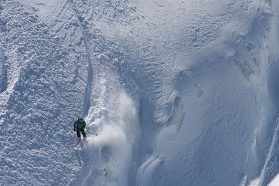 Person skiing on snowcapped mountain