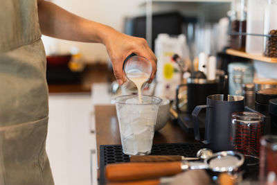 Cropped hands of man preparing coffee
