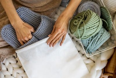 Low section of woman holding wool