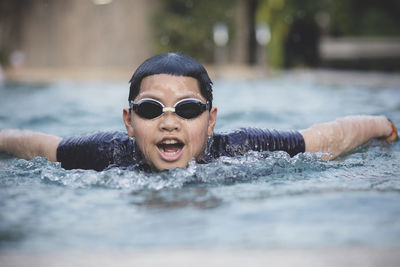 Portrait of boy swimming in pool