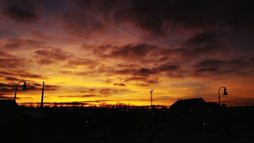 Silhouette built structure against sky during sunset