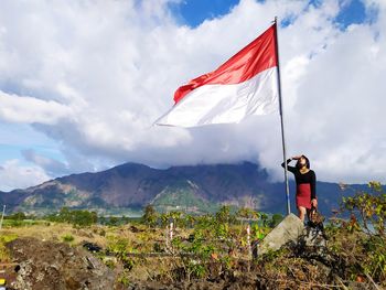 Low angle view of flag against mountain