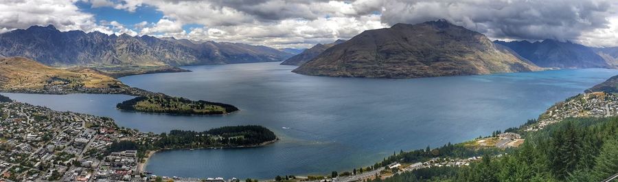 Panoramic view of sea and mountains against sky