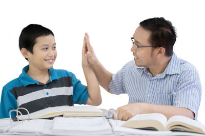 Boy with teacher at table in school