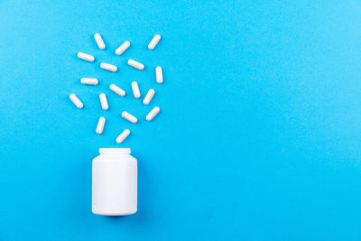 High angle view of bottle on blue background