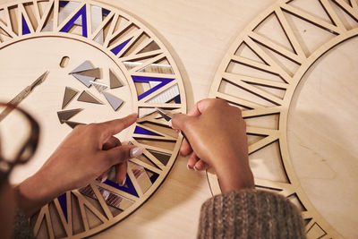 Low section of person assembling a mirror