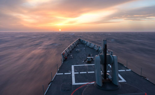 Ship on sea against sky during sunset