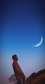 Low angle view of moon against sky at night