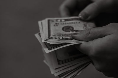 Cropped hand holding paper currency