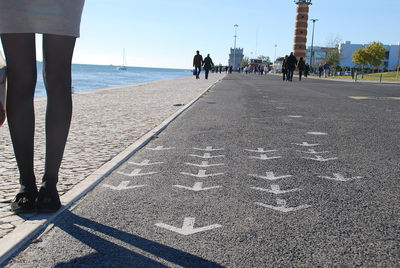 People at beach against sky