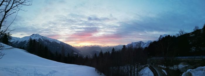 Scenic view of snowcapped mountains against sky during sunset