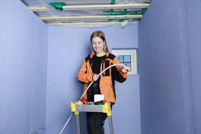 Young woman renovating house