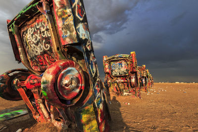 Old abandoned truck on field against sky