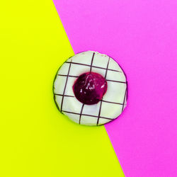 High angle view of multi colored candies against pink background