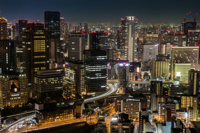 High angle view of city lit up at night