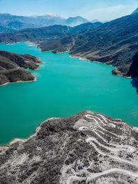 High angle view of lake amidst mountains against sky