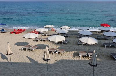 Lounge chairs and parasols on beach