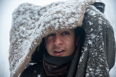 Close-up portrait of man in snow