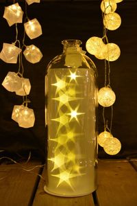 Close-up of illuminated lamp on table