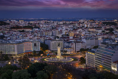 High angle view of illuminated cityscape against sky at night