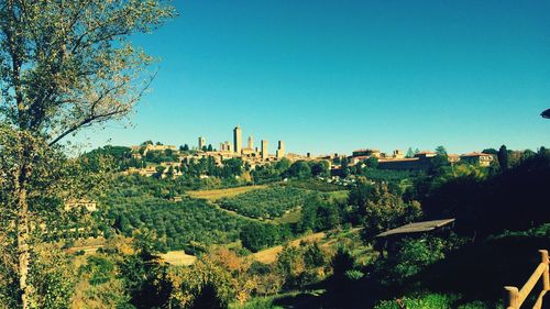 Panoramic shot of cityscape against clear blue sky