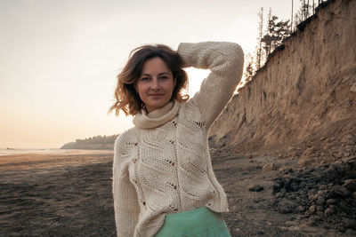 Posing woman in nature. young woman in stylish clothes knitted sweater and long skirt posing 