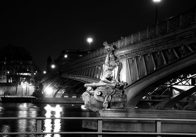 Statue of illuminated city at night