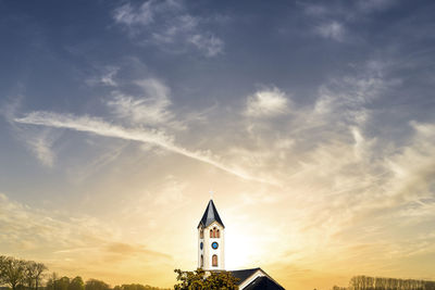 Low angle view of building against sky during sunset