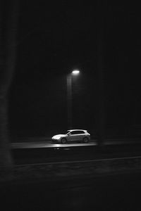 Car on illuminated street at night