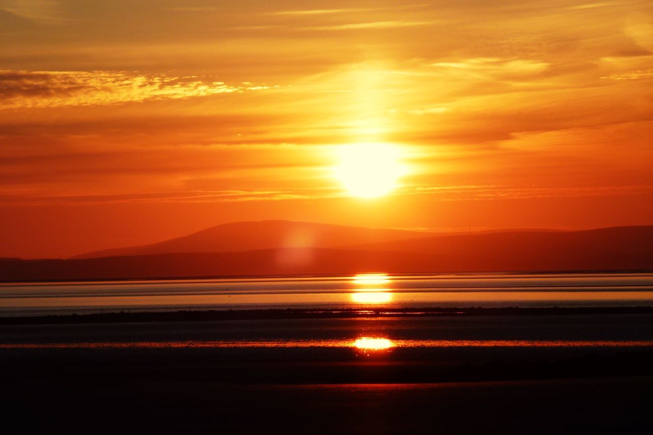 sunset, water, scenics, tranquil scene, beauty in nature, tranquility, orange color, reflection, sky, sun, mountain, sea, idyllic, nature, cloud - sky, silhouette, beach, majestic, lake, sunlight