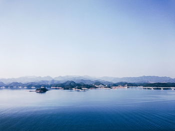 Calm sea with mountain range in background