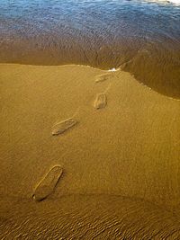 High angle view of footprints on beach