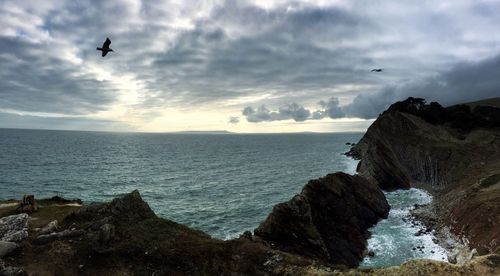 Scenic view of sea against cloudy sky