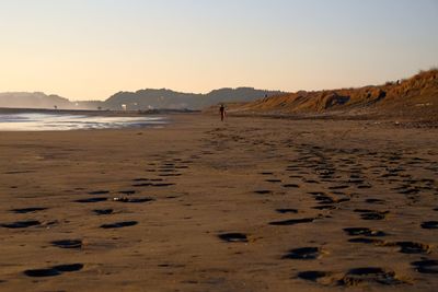 Scenic view of beach against sky during sunset
