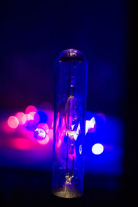 Close-up of illuminated light against blue background