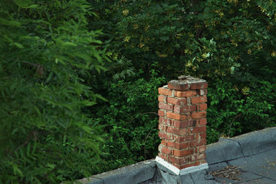 Stack of stone wall by building