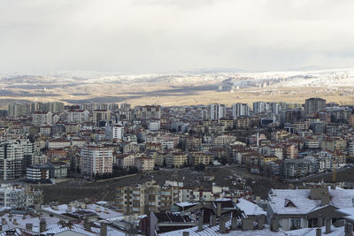 High angle view of buildings in city against sky