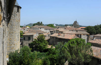 Buildings in city against clear sky