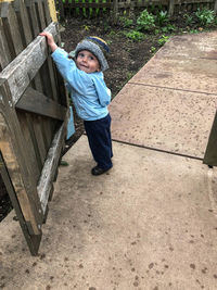 High angle portrait of cute boy standing on footpath