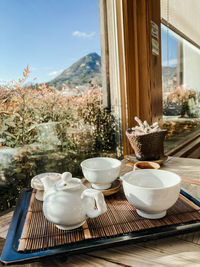 Close-up of tea cup on table against window