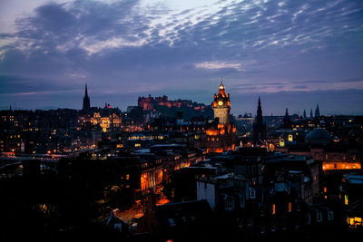 Illuminated cityscape against sky during night