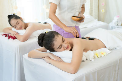 Young woman receiving lastone therapy in spa