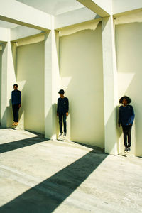 Rear view of people walking in corridor of building