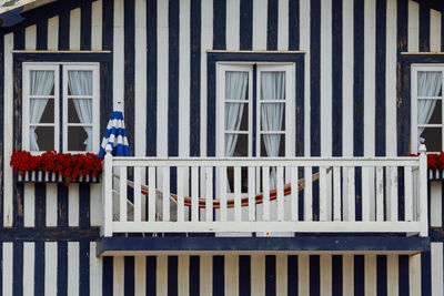 Typical colourful houses with blue and white stripes in costa nova - aveiro against sky