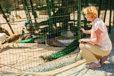 Senior tourist woman on an excursion to the zoo.