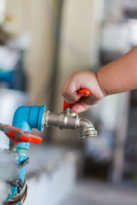 Close-up of hand holding bottle